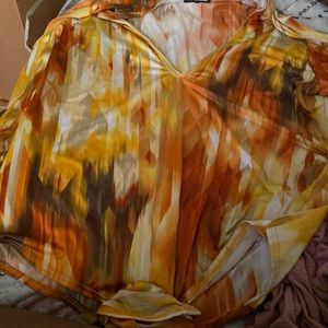 I am selling a multi-colored Fashion Nova bodysuit in the size XL.